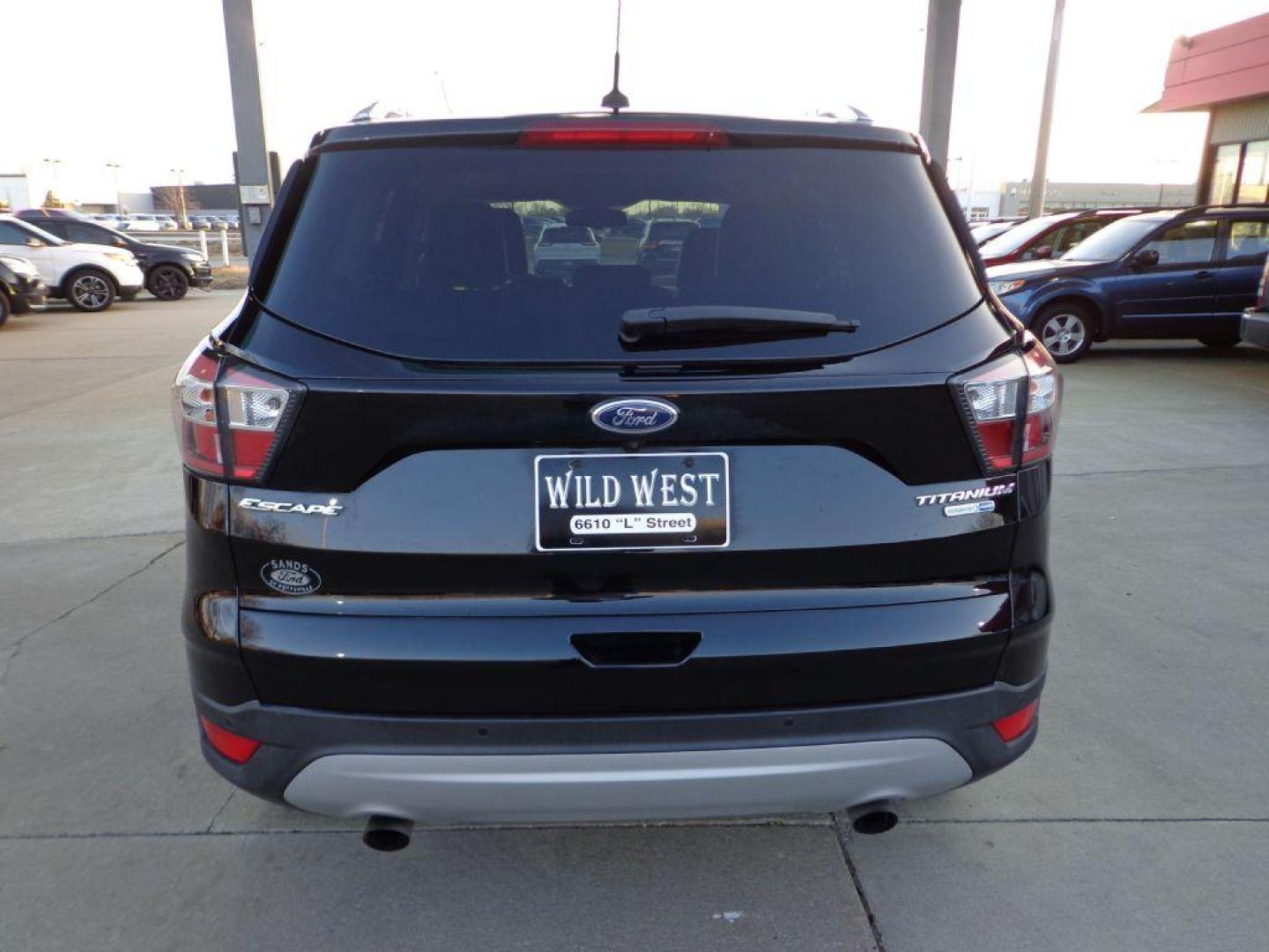 2017 BLACK FORD ESCAPE TITANIUM (1FMCU9J99HU) with an 2.0L engine, Automatic transmission, located at 6610 L St., Omaha, NE, 68117, (402) 731-7800, 41.212872, -96.014702 - SHARP 1-OWNER CLEAN CARFAX LOW MILEAGE LOADED WITH NAV, PANORAMIC ROOF, NEWER TIRES AND MUCH MORE! *****We have found that most customers do the majority of their shopping online before visiting a dealership. For this reason we feel it necessary to have a competitive price on our used vehicles - Photo#4