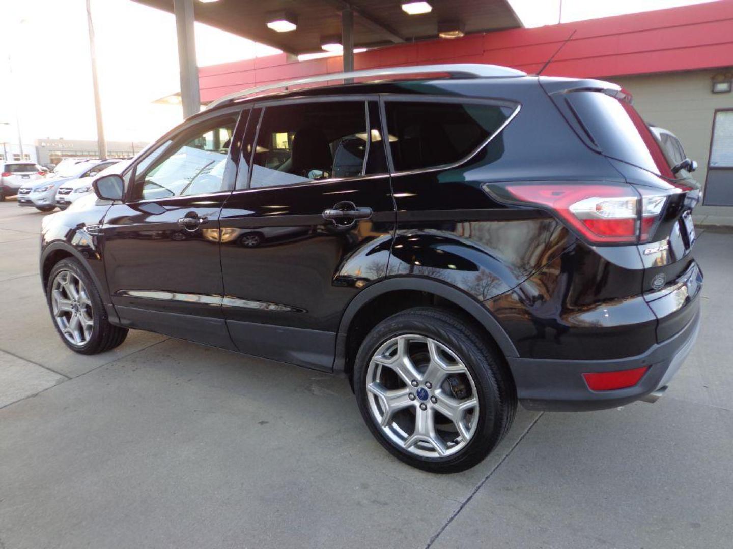 2017 BLACK FORD ESCAPE TITANIUM (1FMCU9J99HU) with an 2.0L engine, Automatic transmission, located at 6610 L St., Omaha, NE, 68117, (402) 731-7800, 41.212872, -96.014702 - SHARP 1-OWNER CLEAN CARFAX LOW MILEAGE LOADED WITH NAV, PANORAMIC ROOF, NEWER TIRES AND MUCH MORE! *****We have found that most customers do the majority of their shopping online before visiting a dealership. For this reason we feel it necessary to have a competitive price on our used vehicles - Photo#5